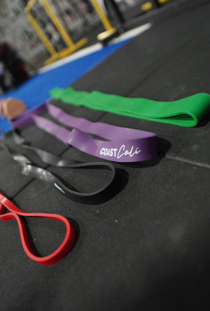 A set of 4 resistance bands on a gym floor